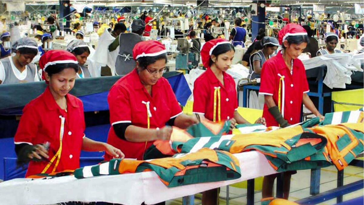 4 female garment production workers inspecting garments in factory