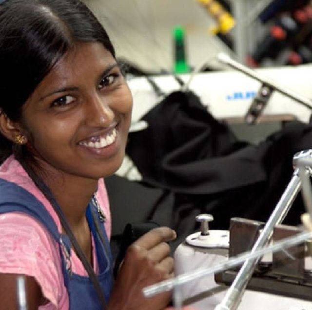 Smiling woman working in a garment factory