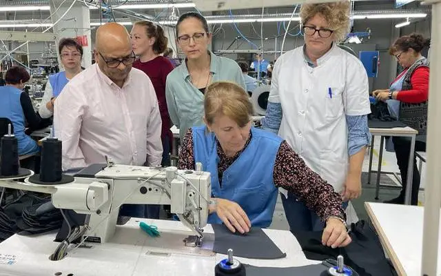 Woman at sewing machine at ODLO Garment factory